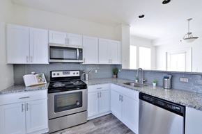 Sterling apartment for rent - a kitchen with stainless steel appliances and white cabinets