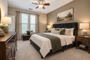 Sterling apartment for rent - A bedroom with a large bed and a painting on the wall.