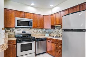 Conshohocken apartment for rent - a kitchen with stainless steel appliances and wooden cabinets