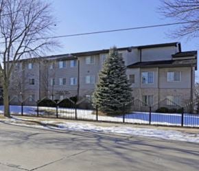 Milwaukee apartment for rent - A large apartment building with a Christmas tree in front.