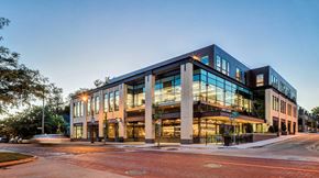 Grand Rapids apartment for rent - an office building with glass windows at dusk