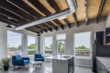 Grand Rapids apartment for rent - a kitchen and living room with windows and a table and chairs