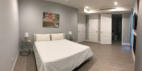 Los Angeles apartment for rent - a bedroom with a white bed and a painting on the wall