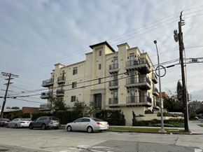 Los Angeles apartment for rent - an apartment building on the corner of a street with parked cars