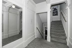 San Francisco apartment for rent - A stairway with a carpeted runner and white walls.