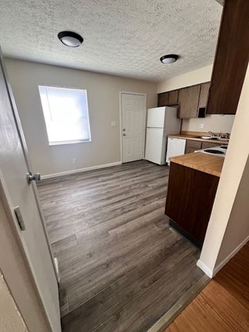 Galloway apartment for rent - A kitchen with a white fridge and wooden floors.