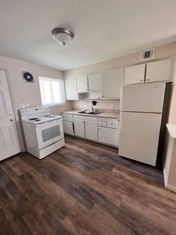Columbus apartment for rent - A kitchen with white appliances and wooden floors.