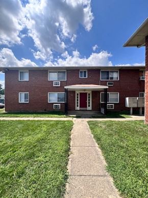 Columbus apartment for rent - A red brick apartment building with a white door and windows.