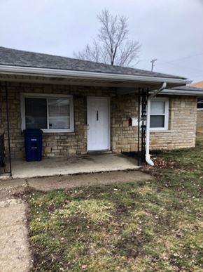 Columbus apartment for rent - A house with a white door and a blue trash can.