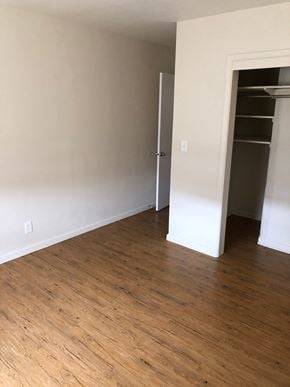 Columbus apartment for rent - A room with a wooden floor and a white door.