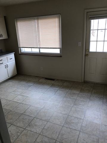 Columbus apartment for rent - A kitchen with white cabinets and a white door.